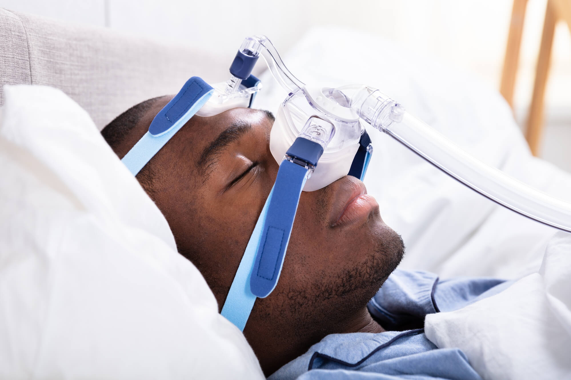 Man using machine for Obstructive Sleep Apnea
