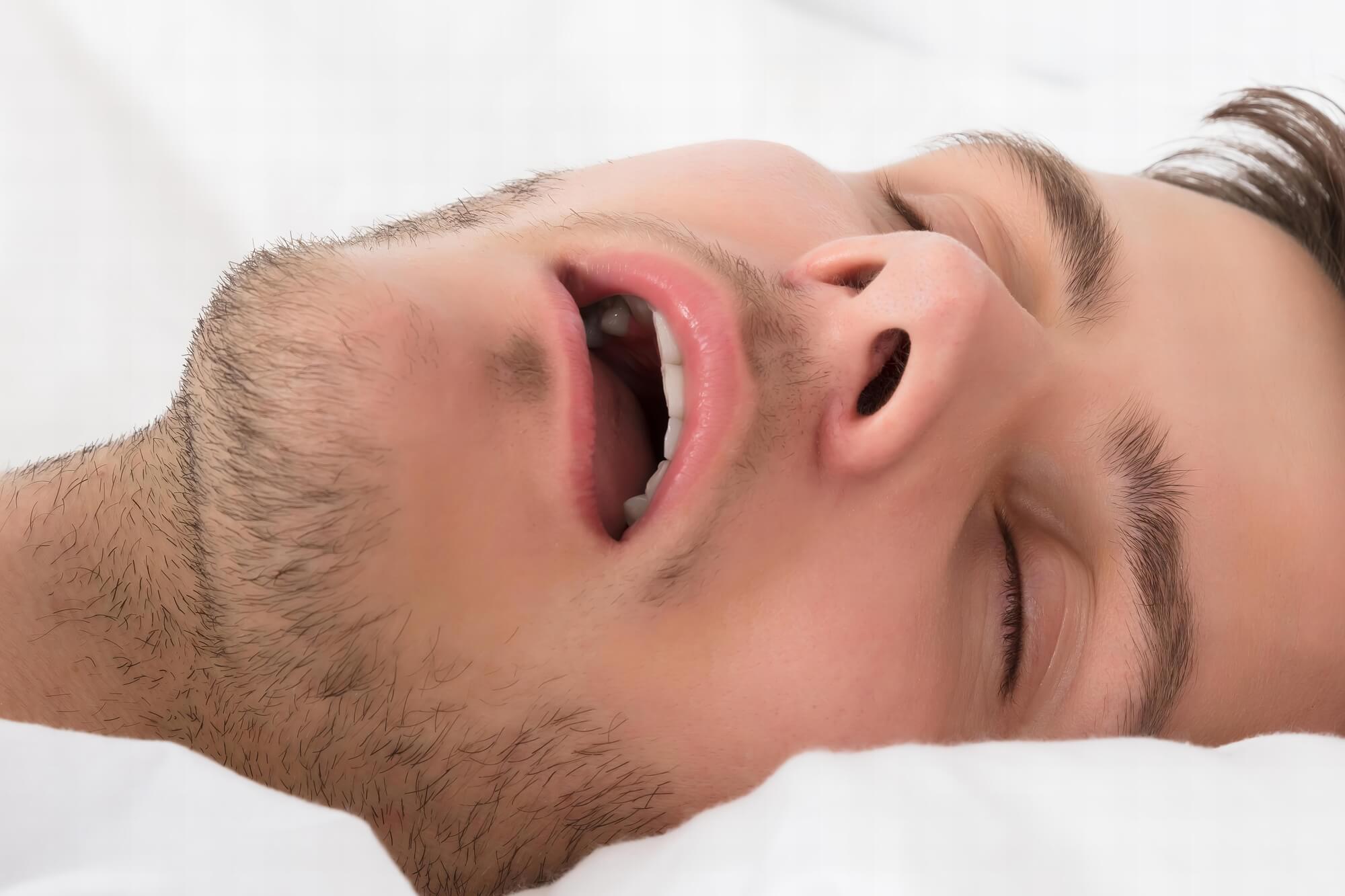 man with sleep apnea snoring